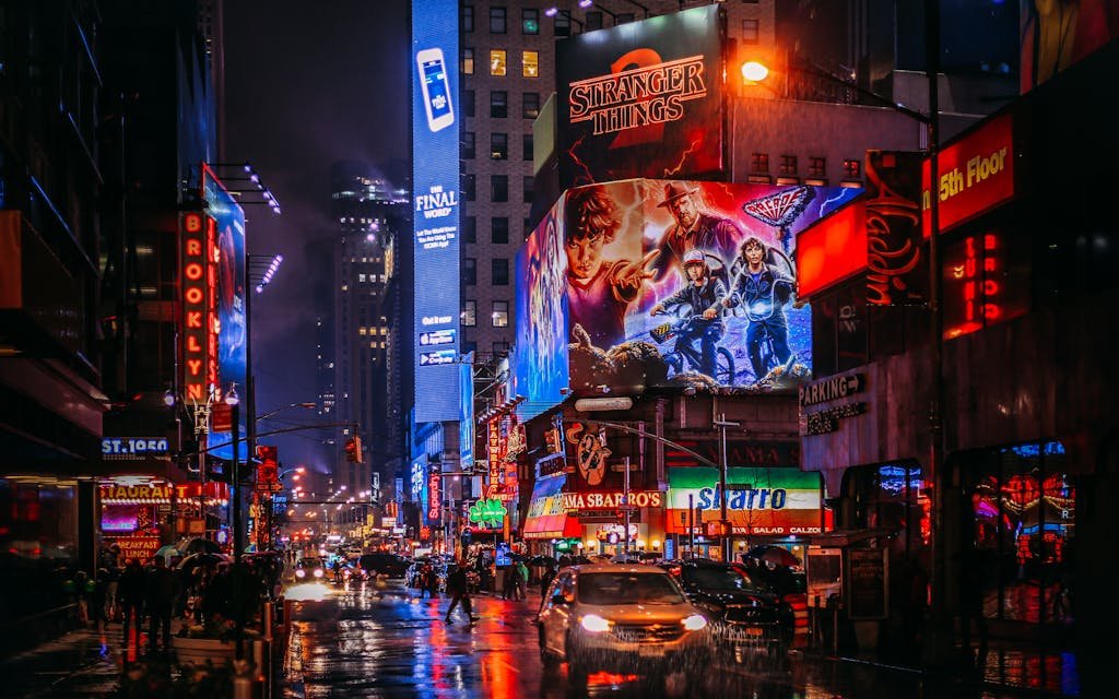 Bustling Times Square street scene in New York City, illuminated by vibrant neon lights and advertisements.