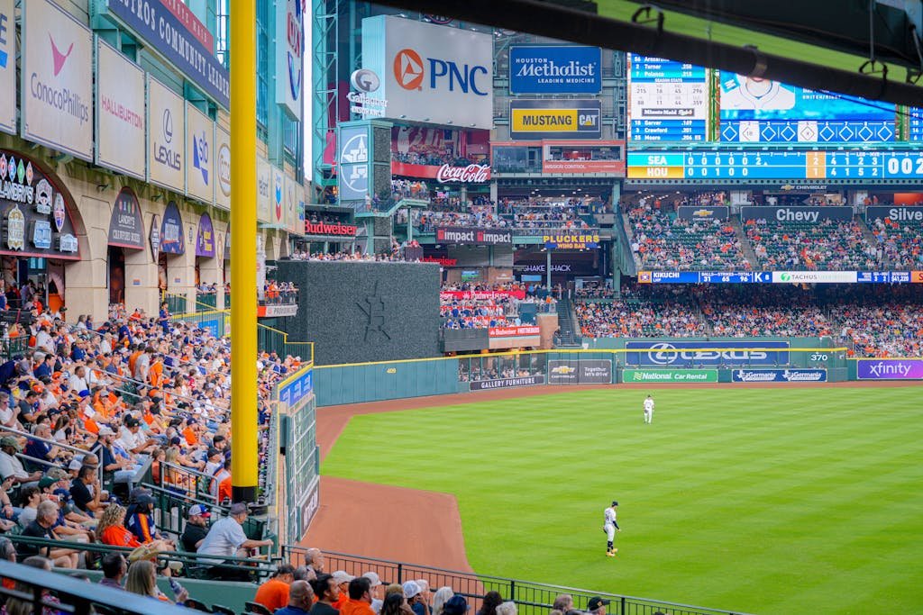 Vibrant baseball game scene with a full stadium, cheering crowd, and bright advertisements.