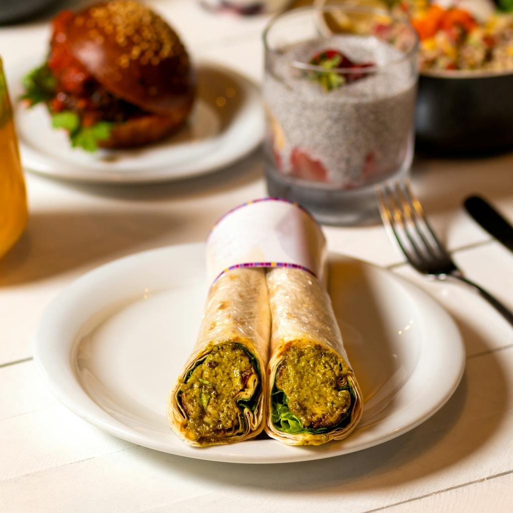 Savory Indian kati roll with flavorful filling served on a white ceramic plate.