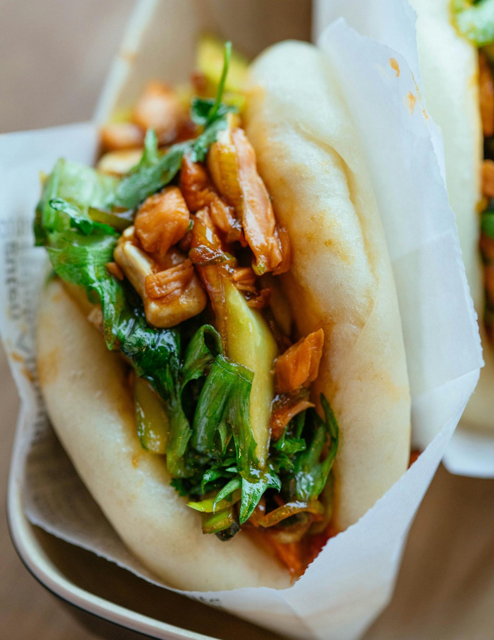 Close-up of delicious Asian bao buns filled with marinated vegetables and meat, perfect for food photography.